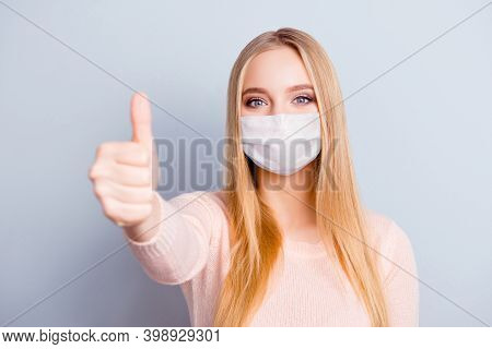 Close-up Portrait Of Pretty Healthy Blonde Girl Wearing Safety Mask Giving Thumbup Isolated On Gray 