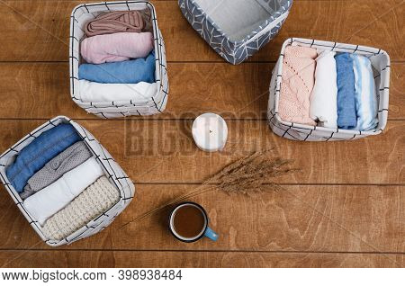 A Group Of Organic Cotton Clothing Laid Out On A Wooden Background Is Ready To Be Folded Into White 