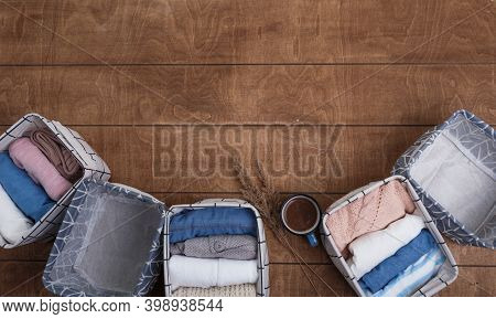 A Group Of Organic Cotton Clothing Laid Out On A Wooden Background Is Ready To Be Folded Into White 