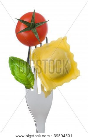 Ravioli Pasta Tomato And Basil On Fork Against White Background