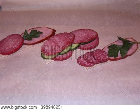 Sandwich With Different Types Of Sausage And Vegetables, Quick Snack. High Quality Photo