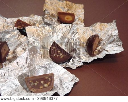 Individual Silver Wrapped Chocolates With Different Fillings In A Box. High Quality Photo