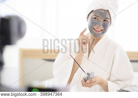 Video Camera Filming Woman In White Bathrobe Applying A Face Mask For Movie, Behind The Scenes Of Sh