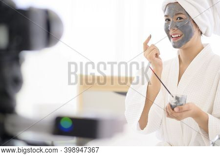 Video Camera Filming Woman In White Bathrobe Applying A Face Mask For Movie, Behind The Scenes Of Sh
