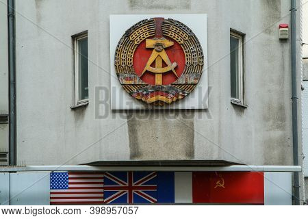The Detail Of The Sign Of The German Democratic Republic On One Of The Houses At Check Point Charlie