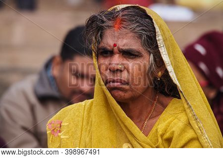 Varanasi, India - Dec 26, 2019: Unidentified Indian Woman With Her Colorful Scarf. Scarf Made Of Ind