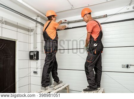 The Workers Are Installing Lift Gates In The Garage.