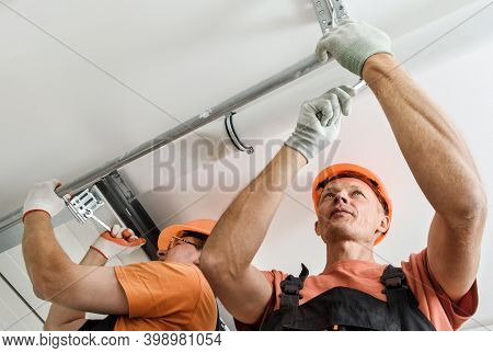 Workers Are Installing Lift Gates In The Garage.
