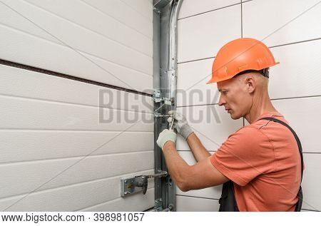 Worker Is Installing Lift Gates In The Garage.