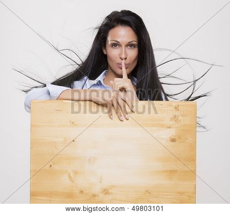 Beautiful woman with blank parole background ask for silence