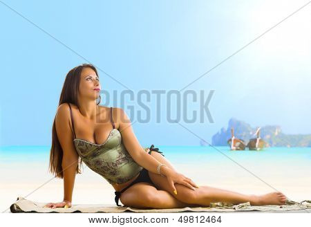 Young woman reaxing on the beach at exotic resort