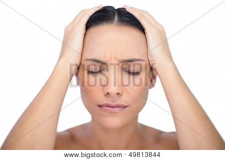 Young woman having strong headache on white background