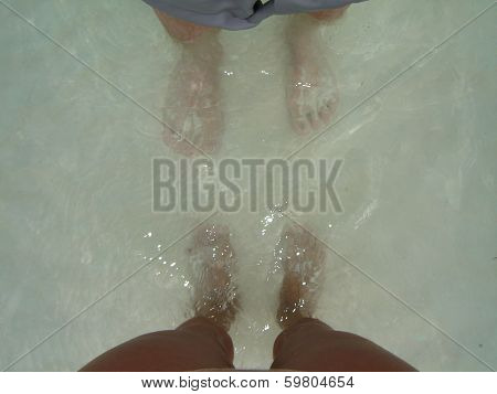 Feet of man and woman at the sea