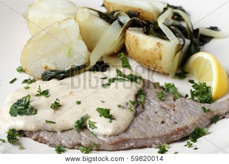 Grilled escalope of veal with a creamy gravy, boiled potatoes with wilted chard, garnished with fresh herbs