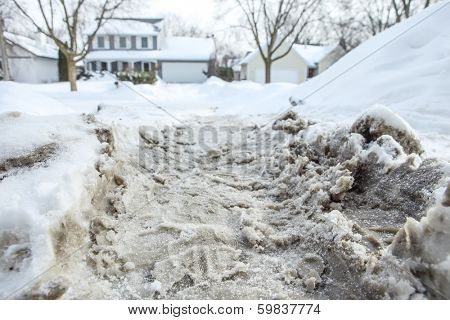 Winter snow tire marks in a driveway