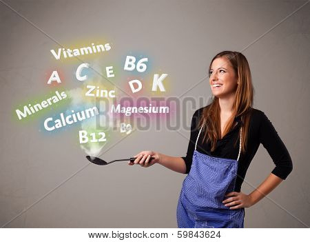 Pretty young woman cooking vitamins and minerals