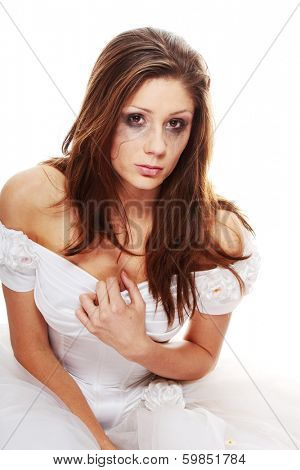 Beautiful young caucasian sad bride crying, over white background