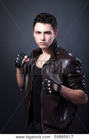 Agressive Muscular Young Man On Black