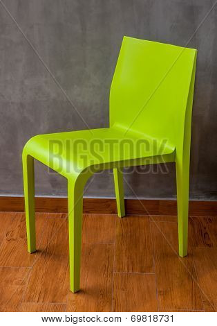 Green Chair On The Wooden Floor With The Grey Concrete Wall