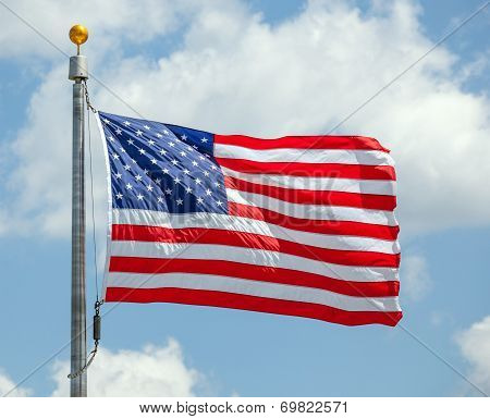 The American Flag Waving On Blue Sky