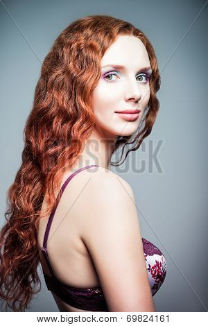 Closeup Studio Portrait Of Pretty Redhead Woman. Half-turned