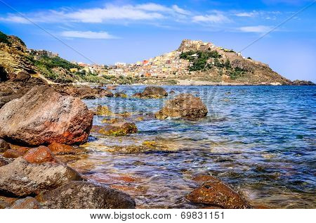 Rocky Ocean Coastline With Colorful Town Castelsardo, Italy