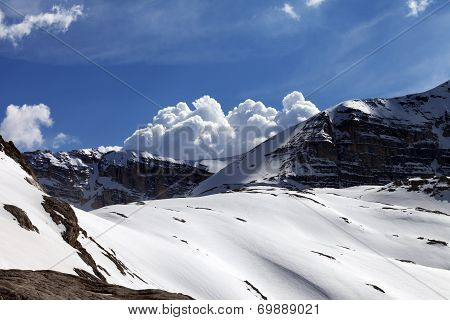 Snow Rocks And Cloudy Blue Sky