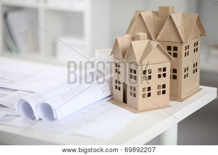Image of new model house on architecture blueprint plan at desk