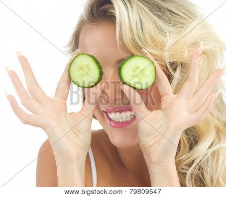 portrait of attractive  caucasian smiling woman isolated on white studio shot eating cucumber