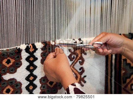 Woman Working At The Loom. Close Up