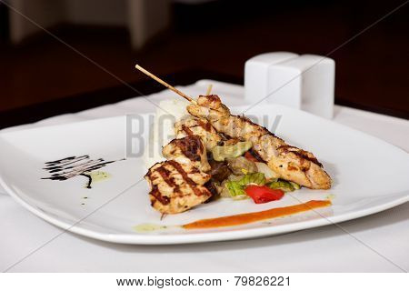Lamb Kebab On White Plate With Cruet