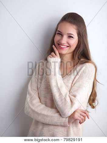 A young woman standing, isolated on graybackground
