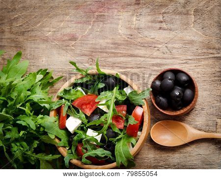 Greek Salad In A Wooden Salad Bowl On The Table