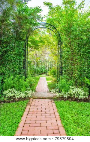 Lush Green Garden With Wrought Iron Arbor