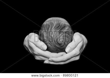 Newborn baby in the comfort and protection of his mothers arms