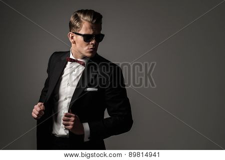 Confident sharp dressed man in black suit 