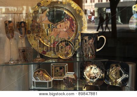 VIENNA, AUSTRIA - AUGUST 20, 2012: Dishes and glasses decorated with motive of the Kiss by Austrian painter Gustav Klimt seen in a souvenir shop window in Vienna, Austria.