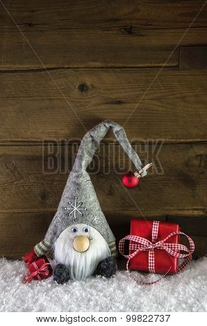 Gnom santa with red christmas presents in rustic country style.