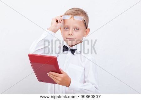Portrait of teen boy with calculator on white background