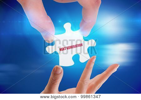 The word next generation and hands holding jigsaw against bright blue sky with clouds