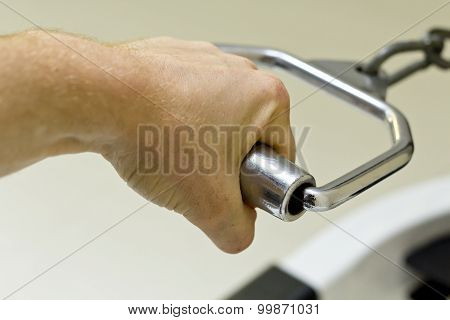 Close up detail of hand working weight lifting exercise machine