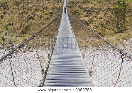 Long Foot Bridge With Walking Woman, Bridge Over Mountain River, Trek To Pokhara, Nepal