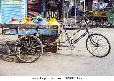 NEW DELHI, INDIA - JULY 3, 2012: three wheeler bike at the market with drinking water and juices. Bikes are still used in India for freight transportation.