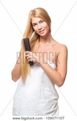 Young attractive blond woman with blue eyes in a towel