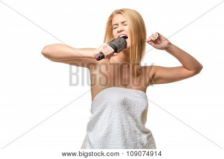 Happy pretty woman in towel singing using comb having fun