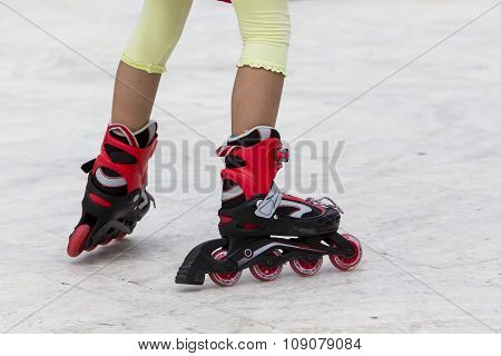 Enjoying roller skating rollerblading on inline skates sport in park. Outdoor activities. Part of human legs in sport shoes.