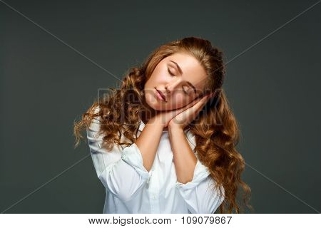 Portrait beautiful young brunette woman with wavy hair, eyes clo