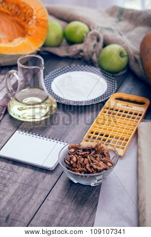 Preparing pie with pumpkins on wooden table, selective focus