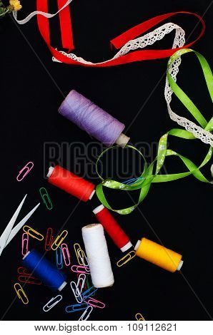 Scissors, bobbins with thread. Set of colored threads in the bobbin with scissors. Sewing kit. Sewin