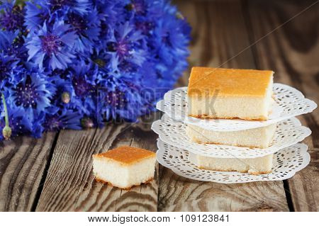 Cottage cheese baked pudding, selective focus, with fowers background